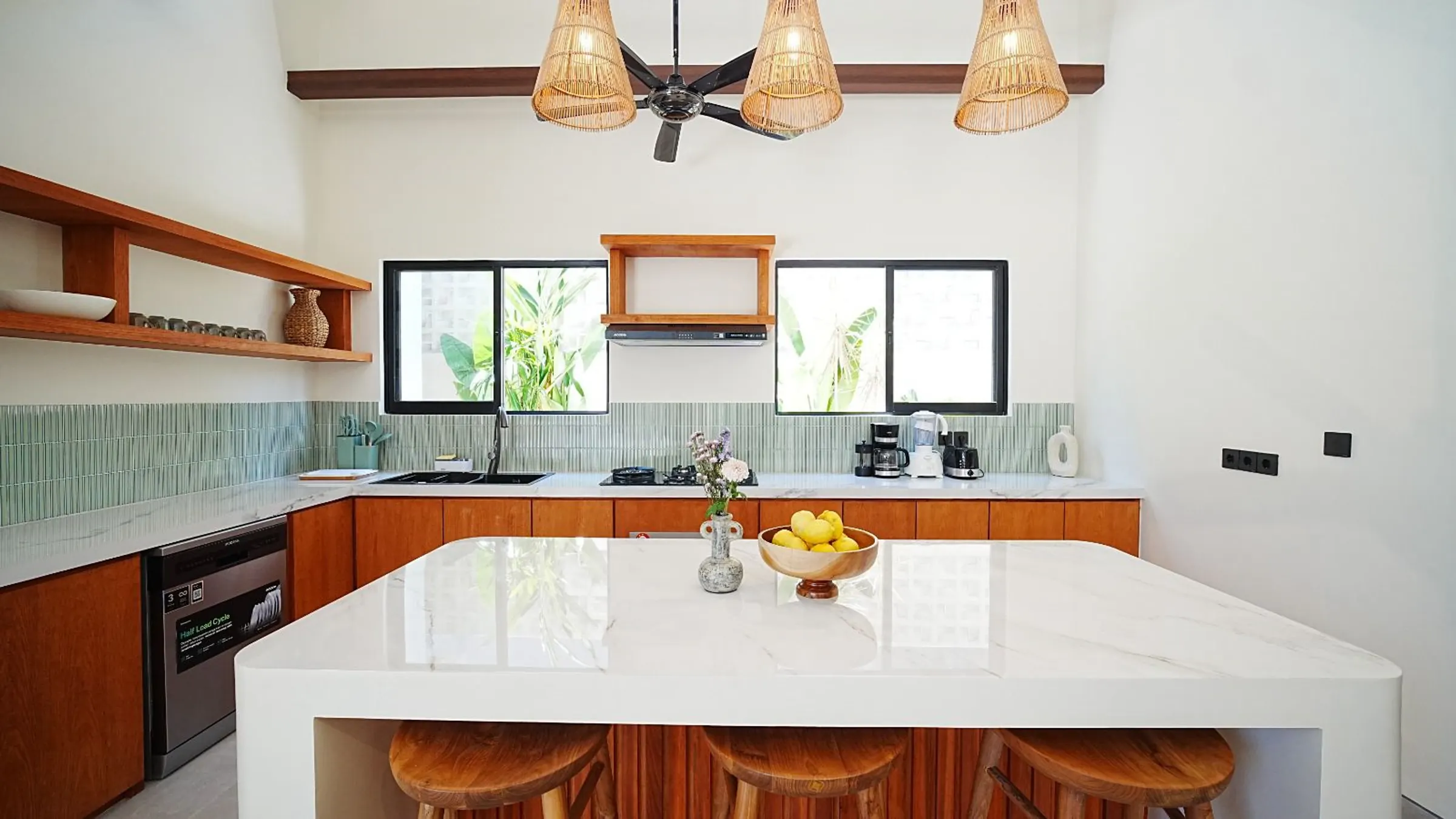 Bright villa kitchen in Bali with timber joinery and an island counter