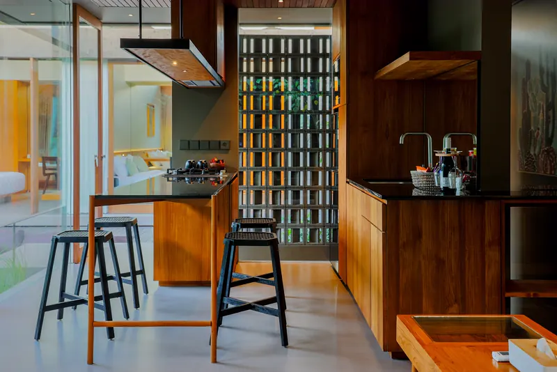 Timber kitchen with a breakfast counter and stools in a Bali home